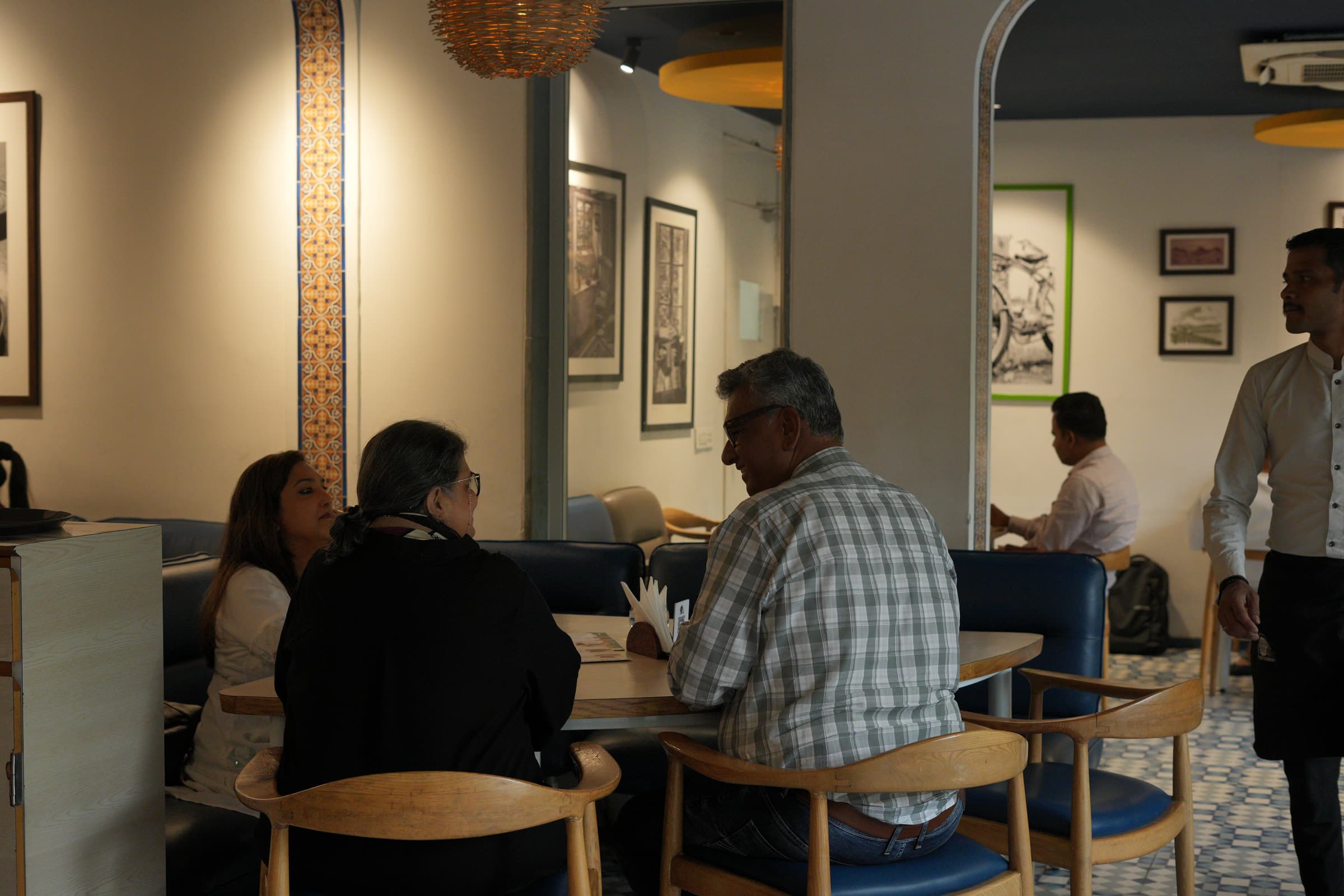 Guests mid-meal in a WeServe-consulted dining room, with staff on the floor